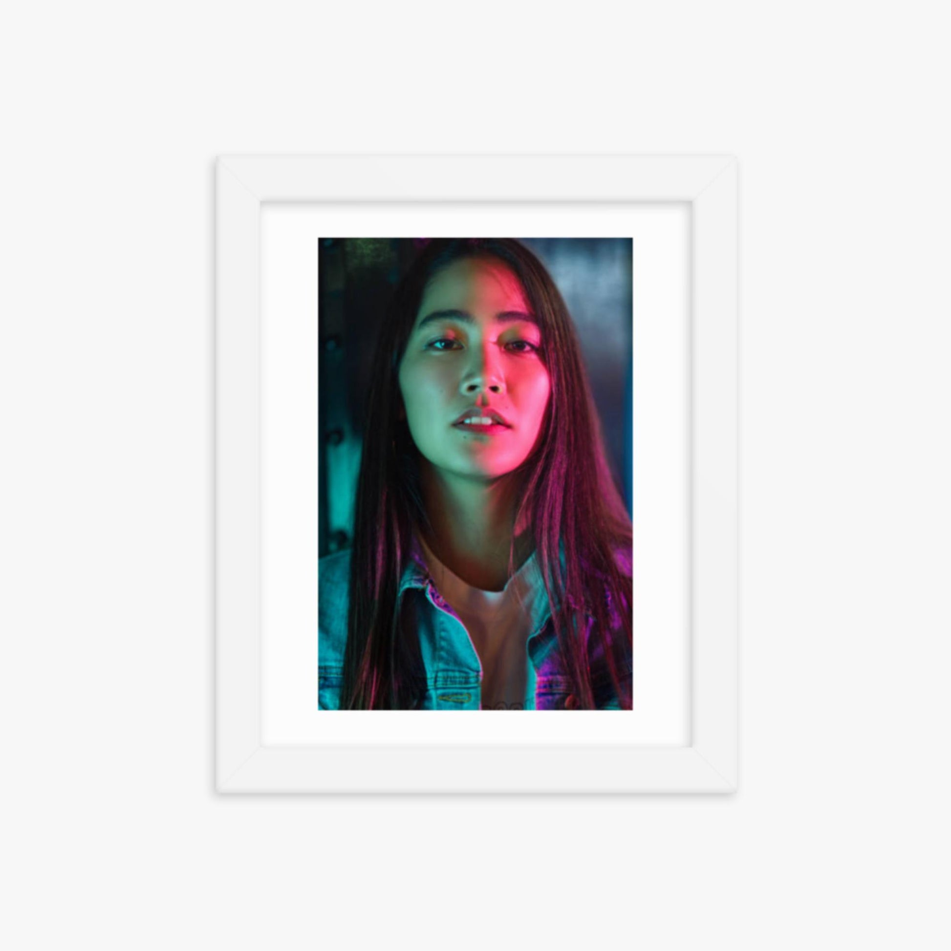 Portrait of young woman lit by colorful neon lights at night 8x10 in Poster With White Frame